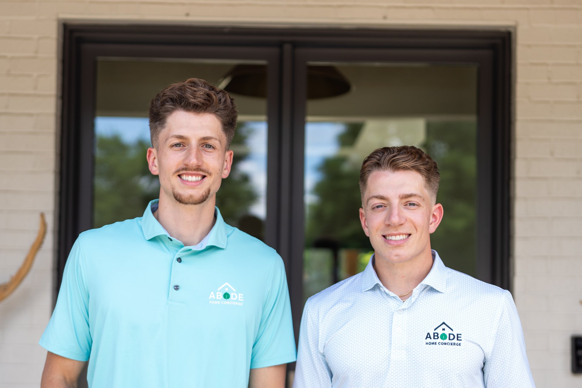 Luke and Ned Morrison of ABODE Home Concierge at the door of a client's home